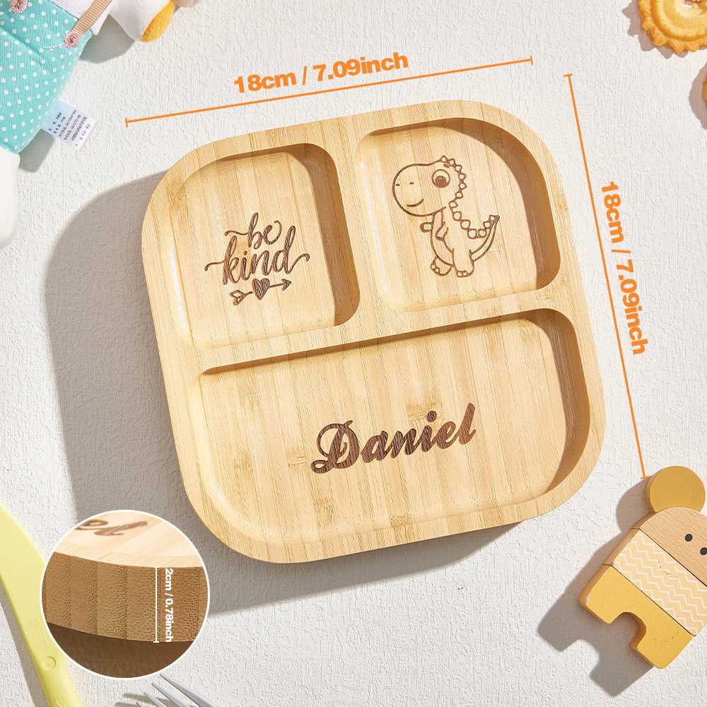 Wooden children's plate with dinosaur and 'be kind' engraving, dimensions displayed.