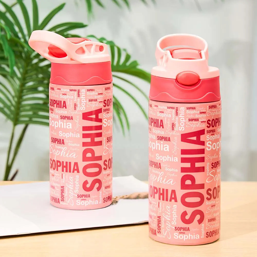 Two pink water bottles with 'SOPHIA' text on a table with a plant in the background
