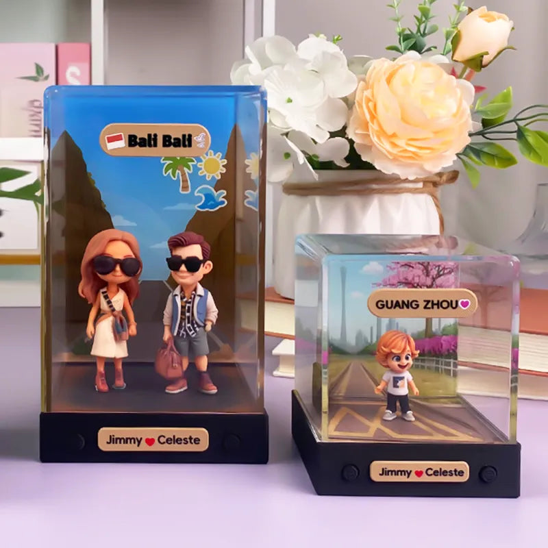 Two figurine displays with 'Bali Bali' and 'Guangzhou' themes on a table with flowers in the background.