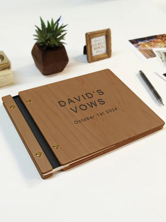 Wooden album with 'DAVID'S VOWS' engraving on a white surface