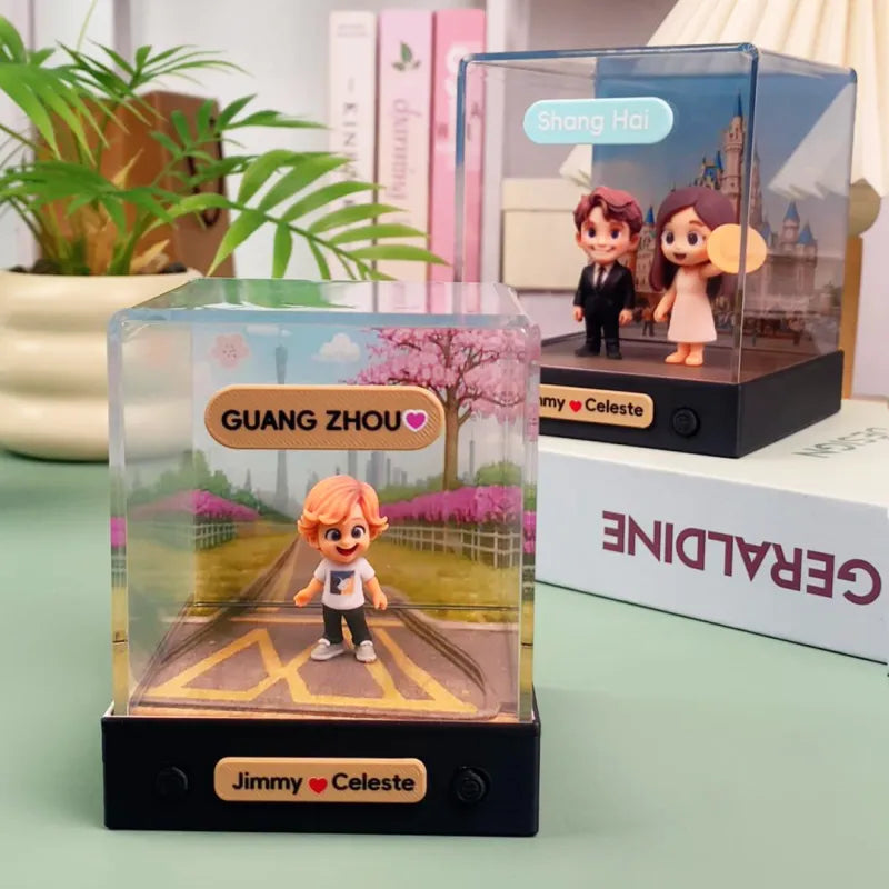 Toy figures in clear display cases with 'Guangzhou' and 'Jimmy loves Celeste' text on a light green surface.