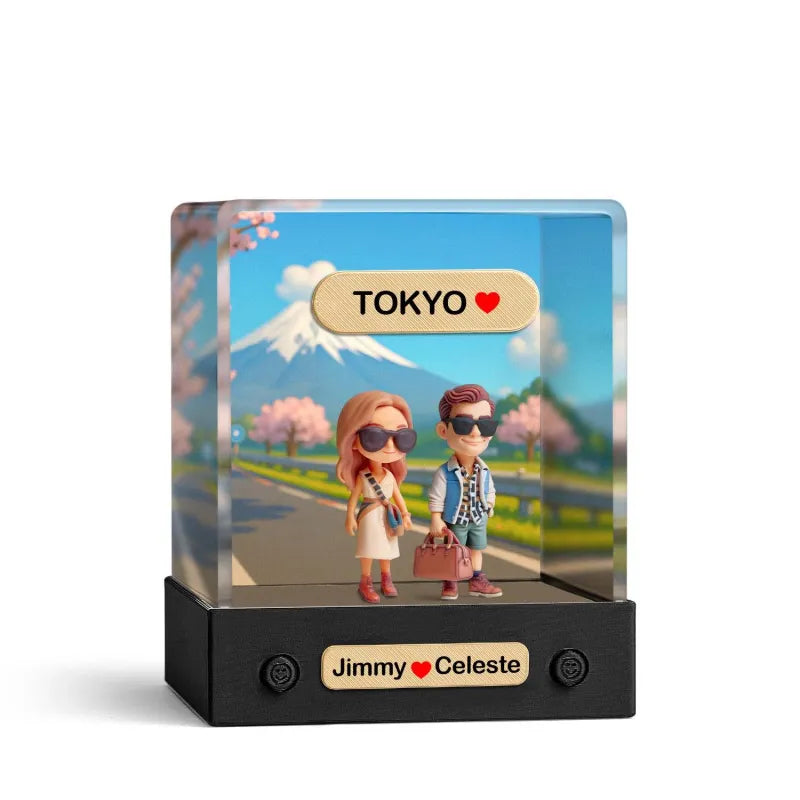 Decorative display with cartoon characters holding hands in front of a scenic background with 'Tokyo' text.