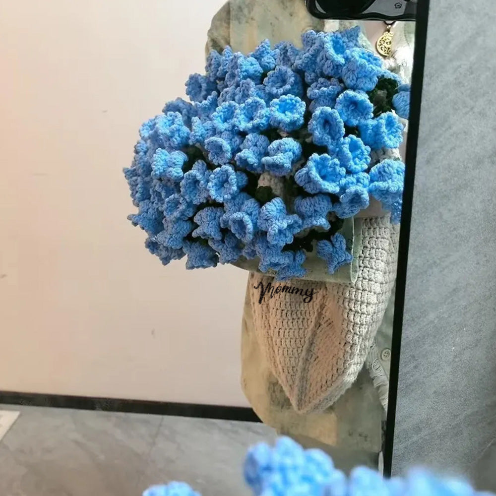 Bouquet of blue flowers in a woven basket with a blurred background