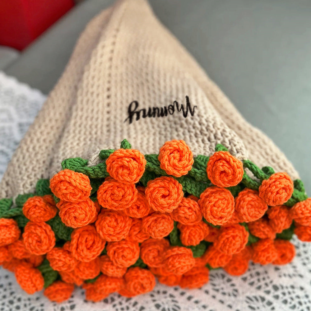 Knitted bag with orange flowers and green leaves on a textured surface