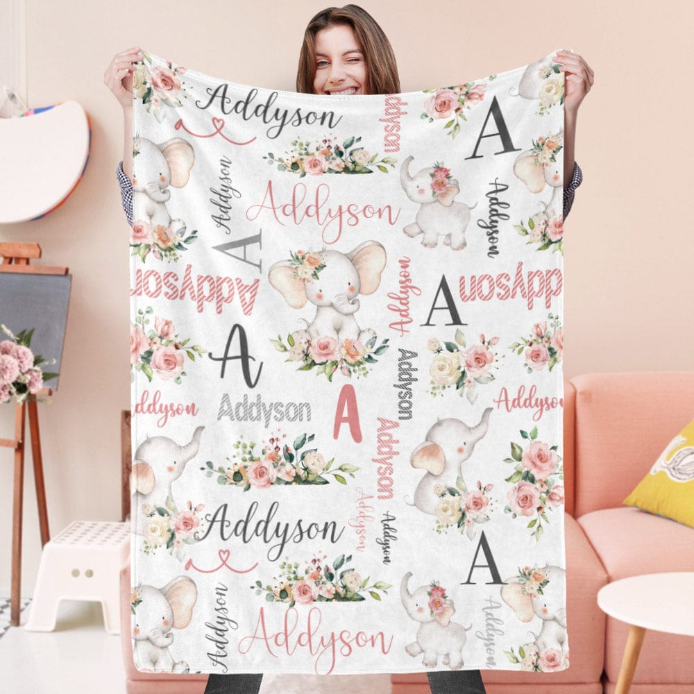 Person holding a personalized blanket with floral and elephant designs.