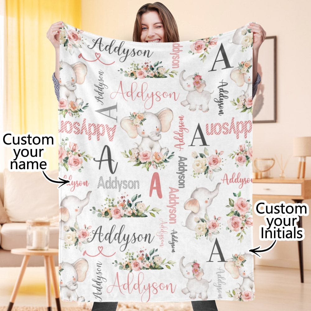 Person holding a personalized blanket with floral and elephant designs, customizable text.
