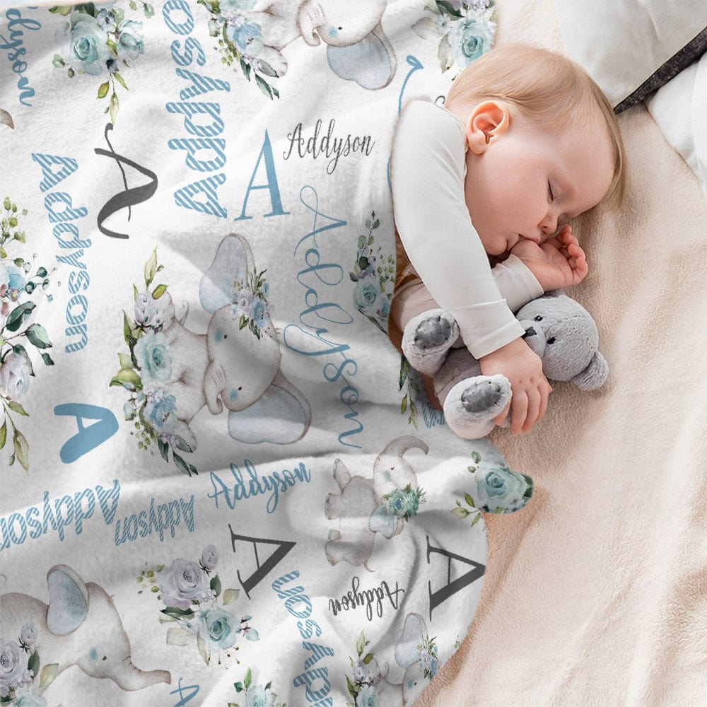 Baby sleeping under a personalized blanket with elephant designs and the name 'Addyson'.