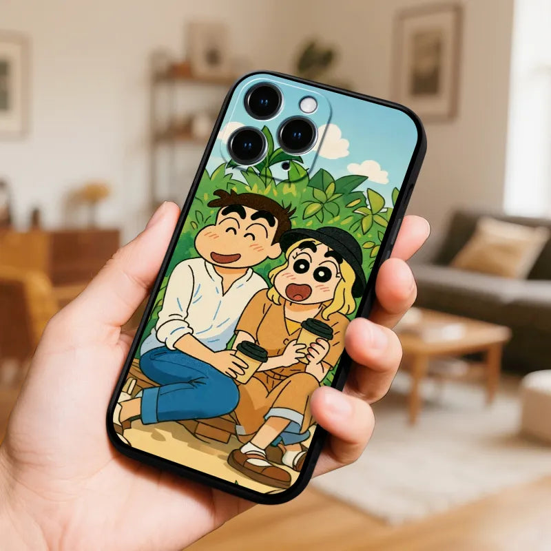 Phone case with cartoon characters held in a hand, living room background