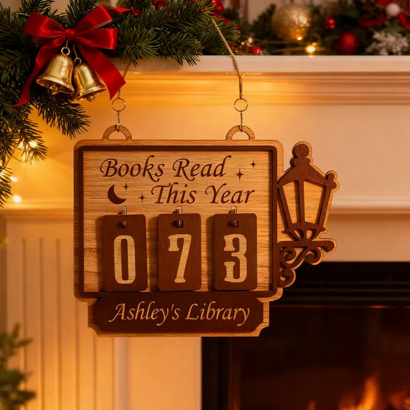 Wooden ornament with 'Books Read This Year' counter and 'Ashley's Library' text, decorated with Christmas elements.