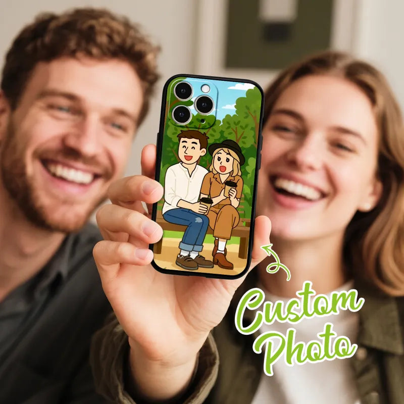 Two people holding a phone case with a cartoon design of a couple sitting on a bench.