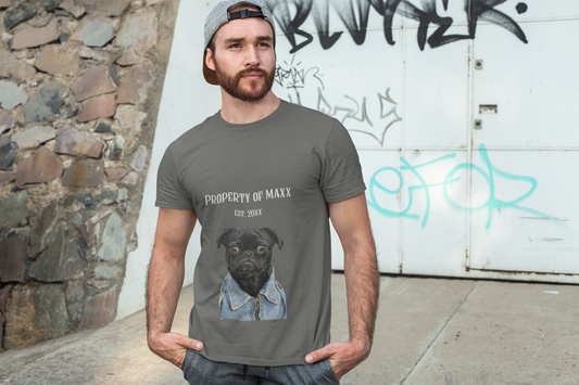 Man wearing a gray t-shirt with a dog graphic and text, standing against a graffiti-covered wall.