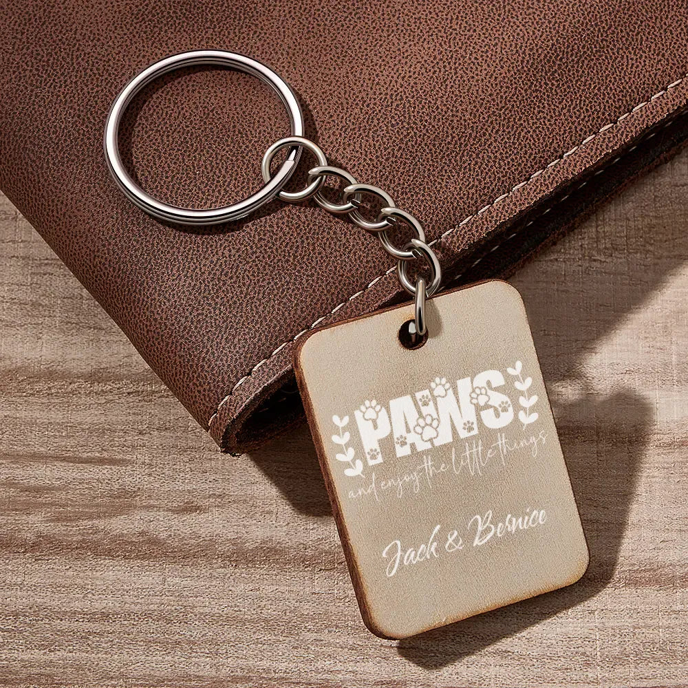 Keychain with engraved text on a wooden surface