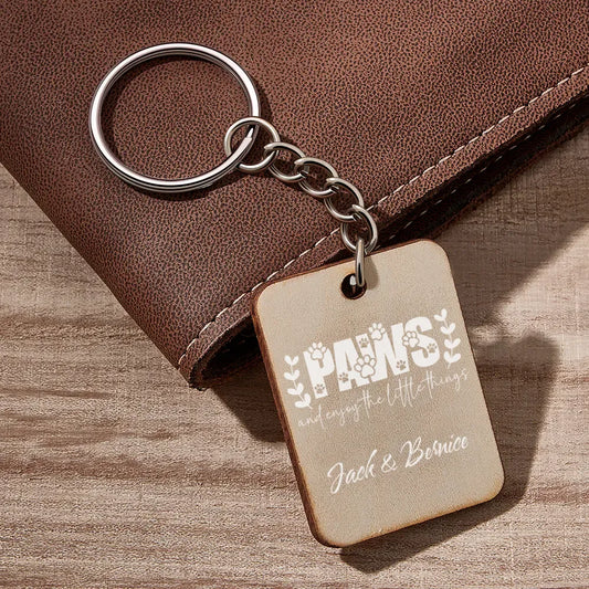 Keychain with engraved text on a wooden surface