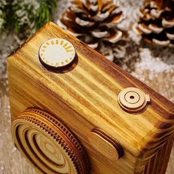 Wooden camera model with decorative elements on a textured background