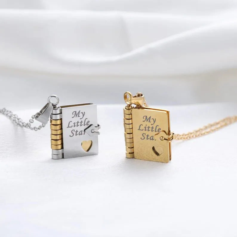 Two book-shaped pendants with 'My Little Star' engraving on a white background