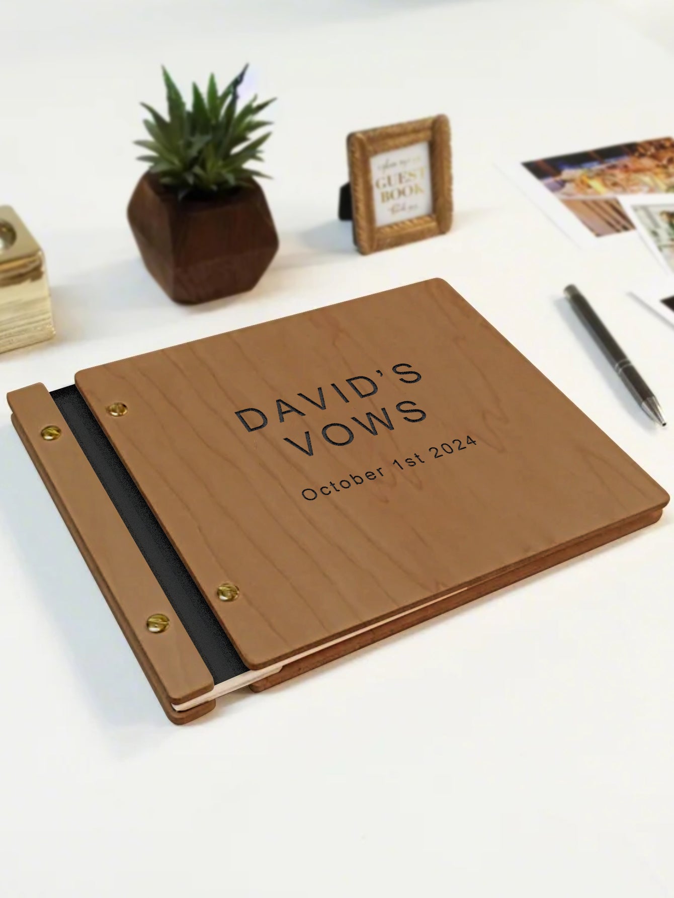 Wooden album with 'DAVID'S VOWS' engraving on a white surface