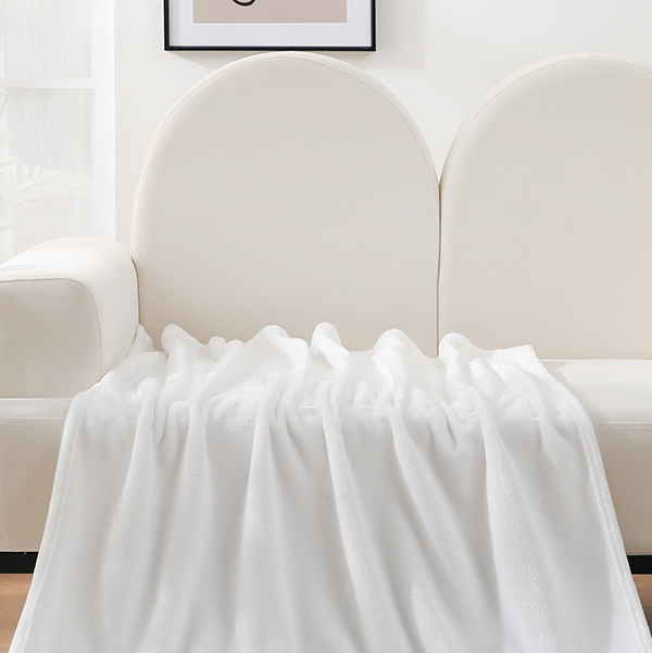 White blanket draped over a chair with a neutral background