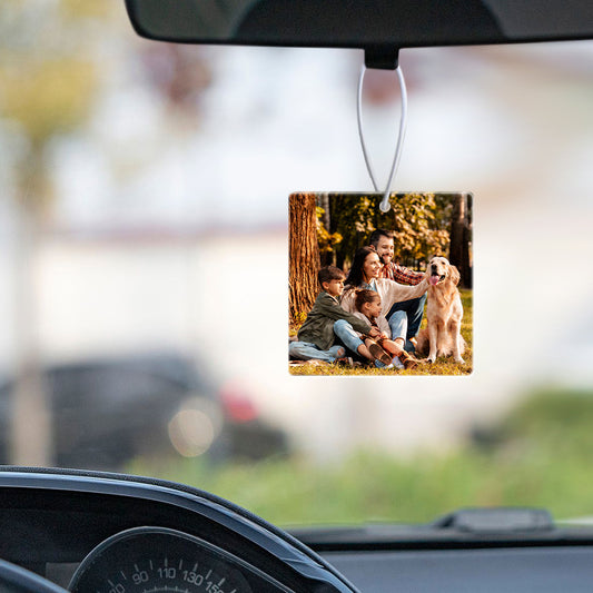 Personalized photo car air freshener hanging from a car's rearview mirror.