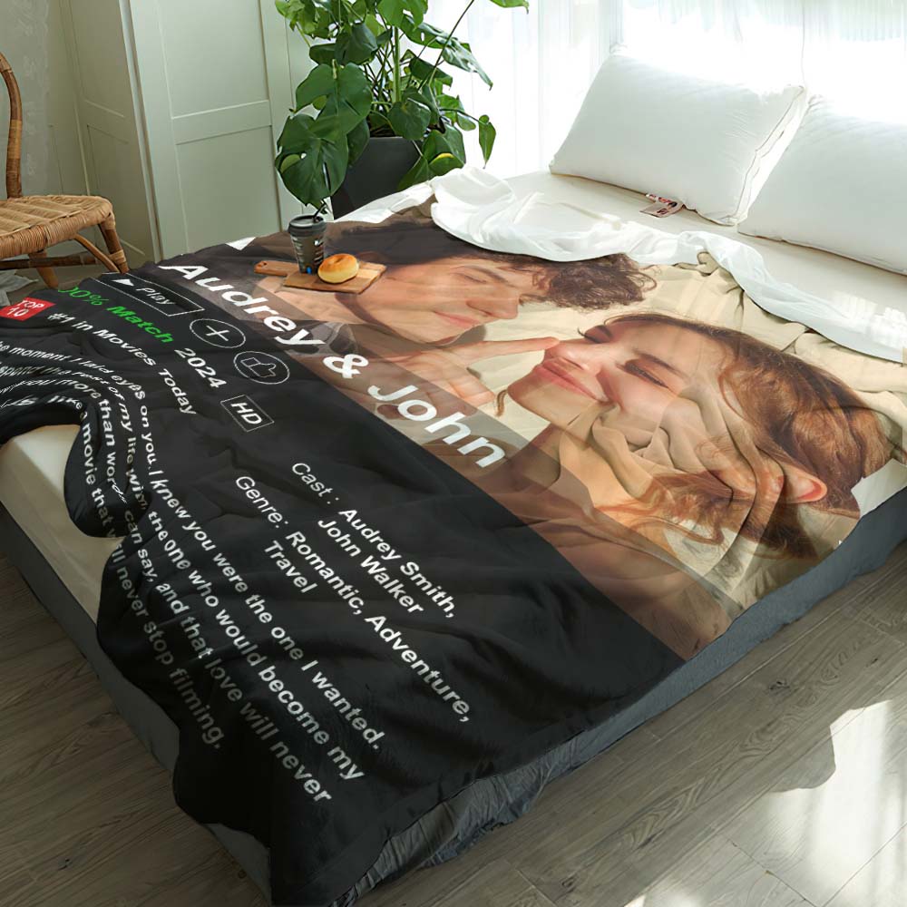 Blanket with a printed design of two people embracing, text, and a plant in the background.