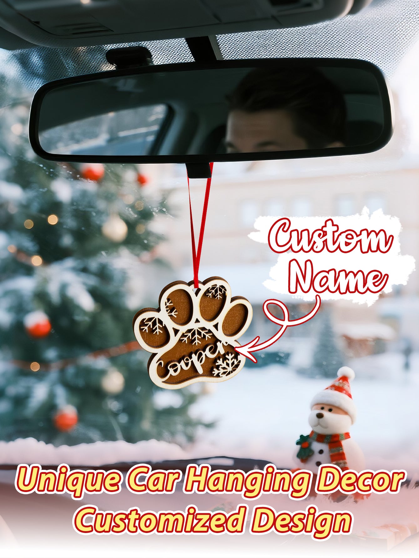Car interior with a paw print ornament and customizable text on a snowy day.