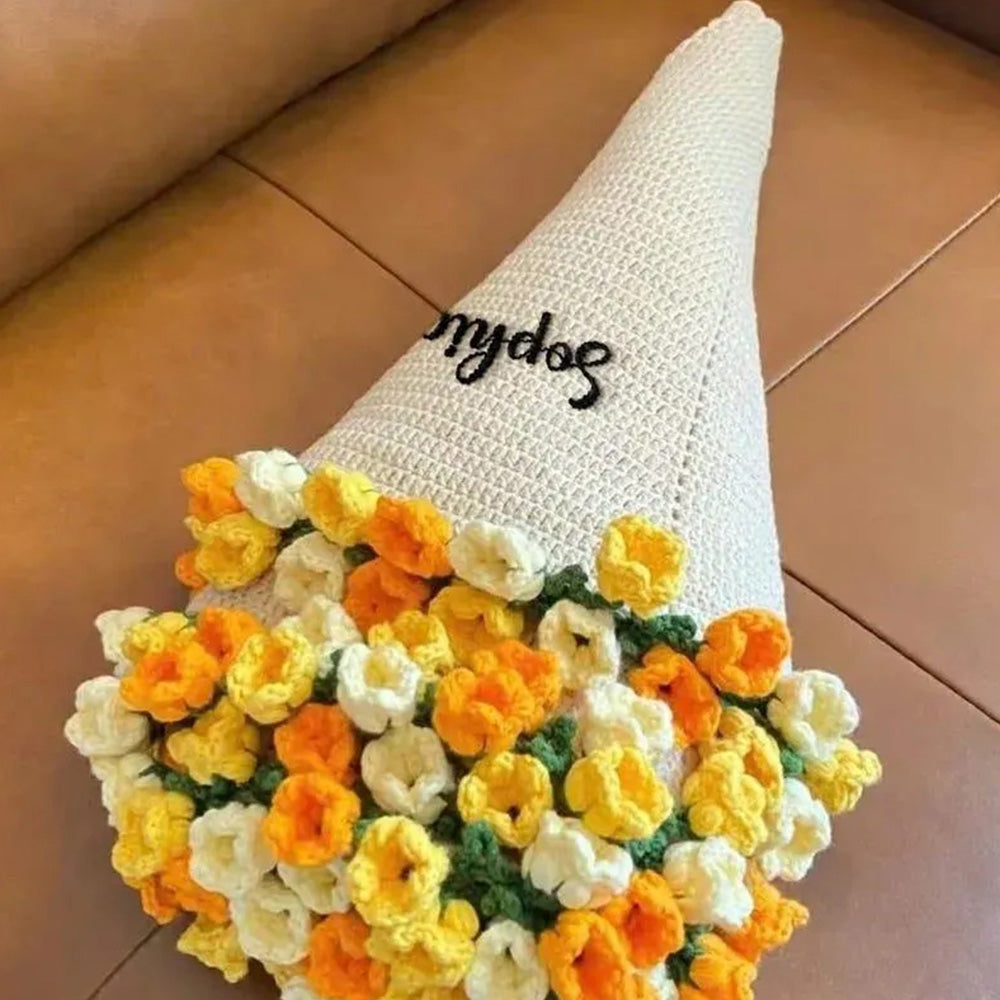 Crocheted gnome hat with flower pattern on a brown surface