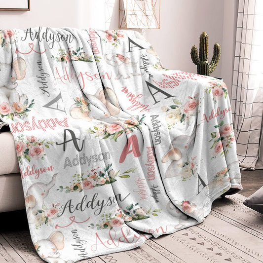 Floral and elephant patterned blanket with 'Addyson' text draped over a couch.