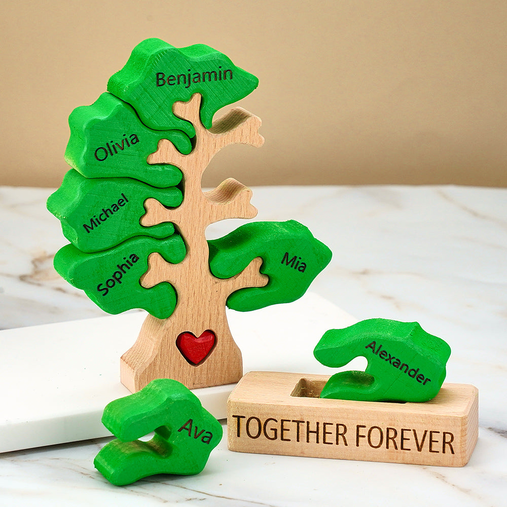 Wooden family tree puzzle with green leaves and wooden base, on a marble surface.