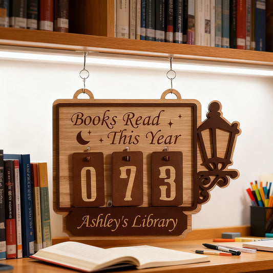 Wooden plaque with 'Books Read This Year' display in a library setting