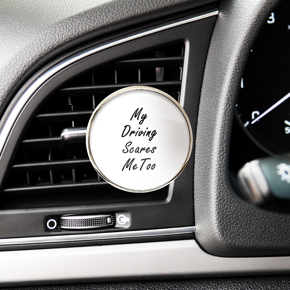 Car air freshener with 'My Driving Scares Me Too' text inside a car vent.