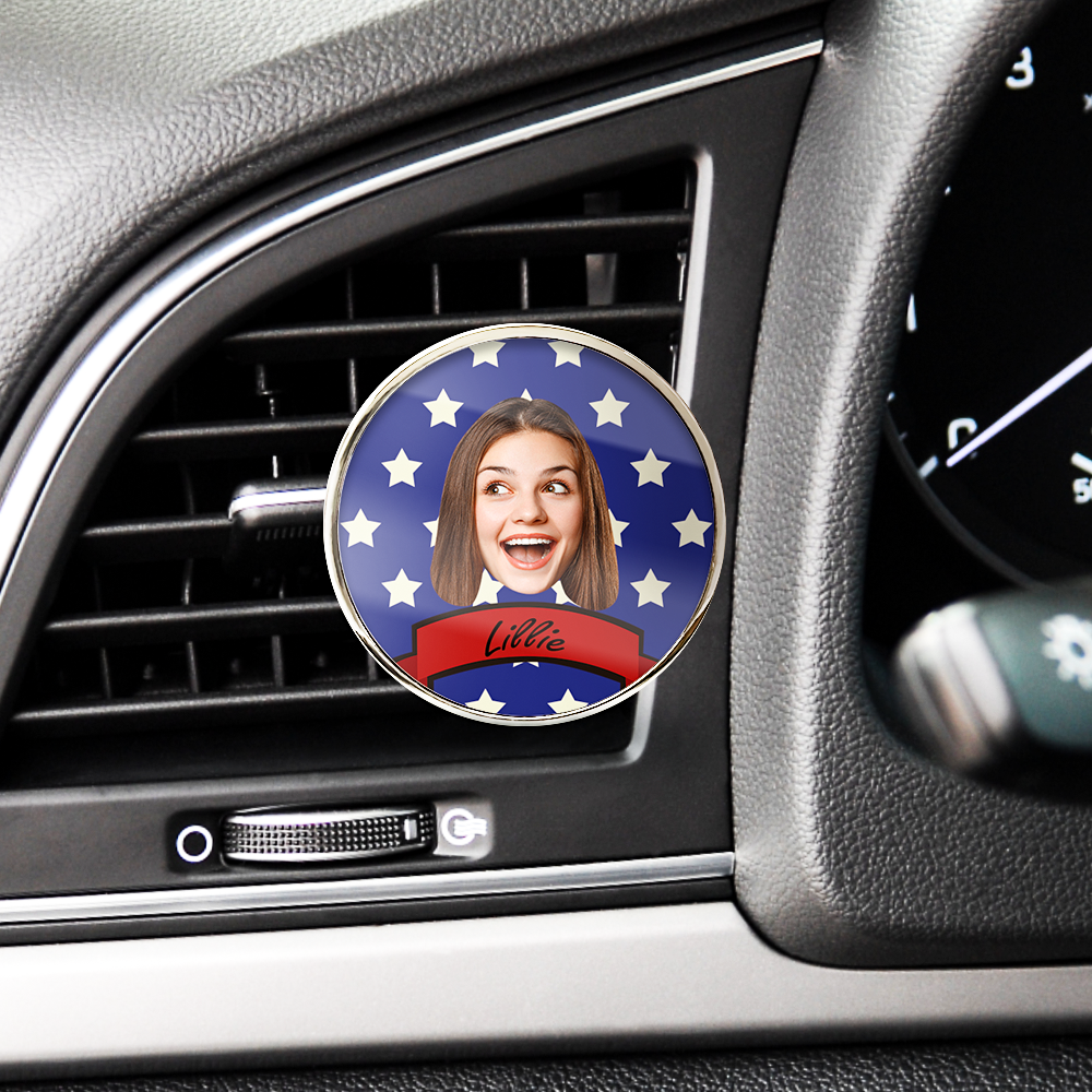 Car air freshener with a personalized design of a woman's face on a dashboard.