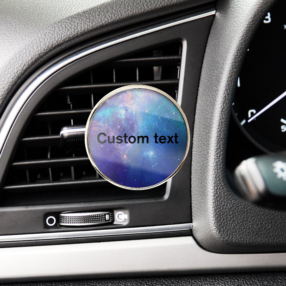 Car air freshener with 'Custom text' on a galaxy design in a car's air vent.