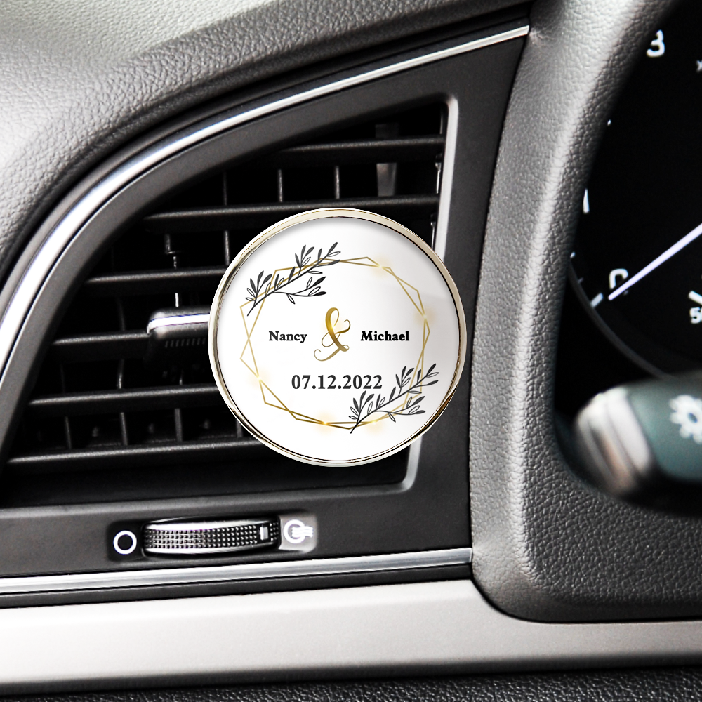 Personalized car air freshener with decorative design and text inside a car's air vent.