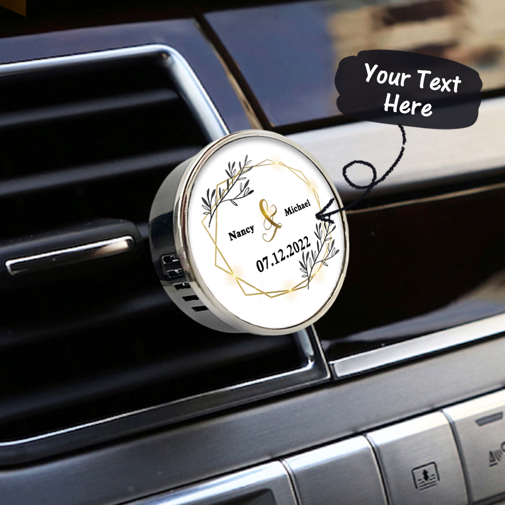 Personalized car air freshener with decorative design and text on a car vent.