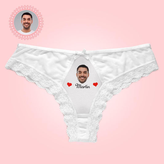White lace underwear with a printed face and name on a pink background