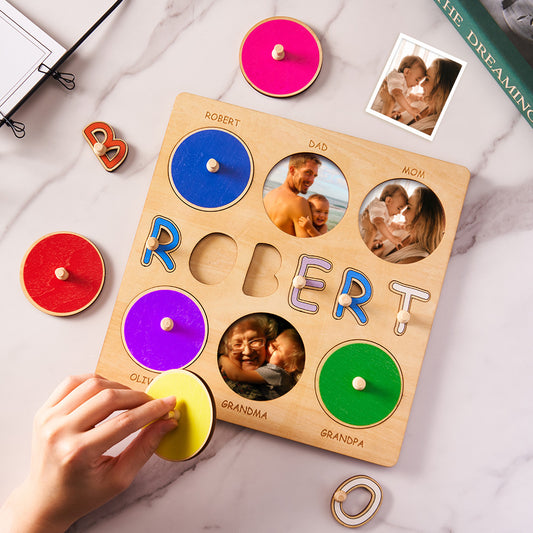 Wooden puzzle with colorful letters and family photos on a marble surface