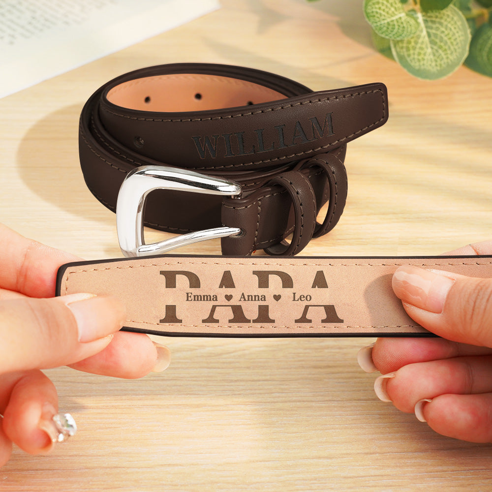 Brown leather belt with engraved name and personalized message on a wooden surface