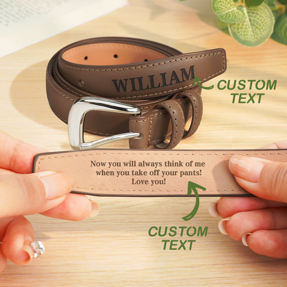 Brown leather belt with engraved message and customizable text on a wooden surface