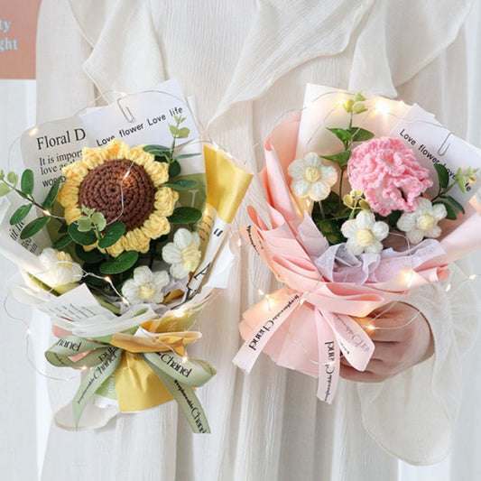 Two floral bouquets with ribbons held by a person wearing a white shirt.