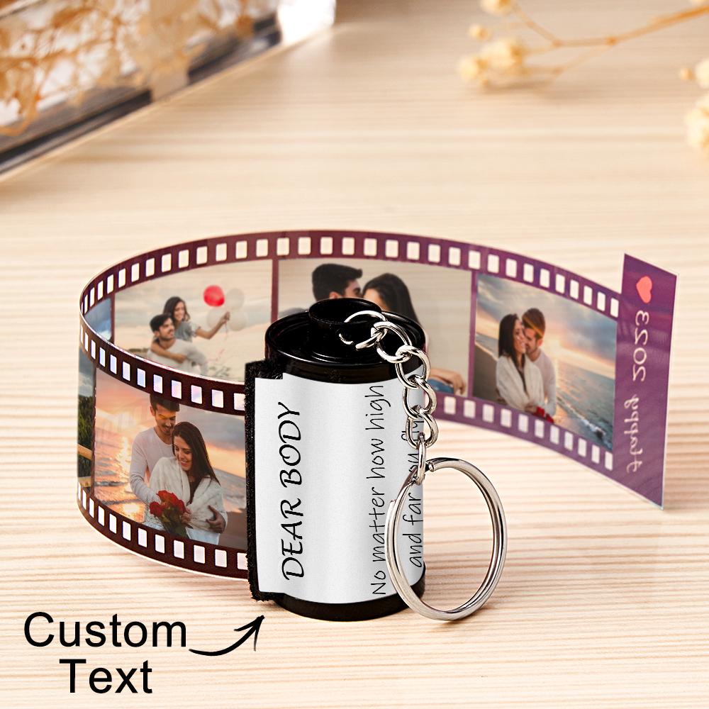 Personalized keychain with photo strip and customizable text on a wooden surface