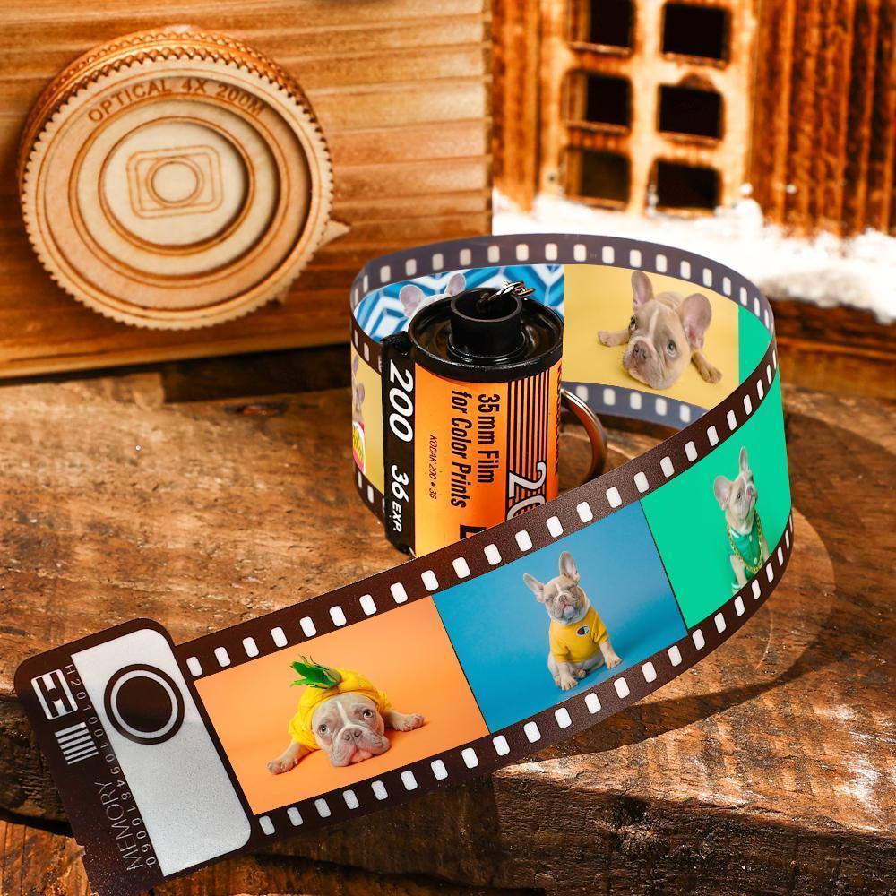 Film strip with images of a dog wearing a pineapple costume on a wooden surface.