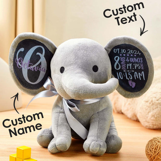 Gray elephant plush toy with customizable text on a wooden surface