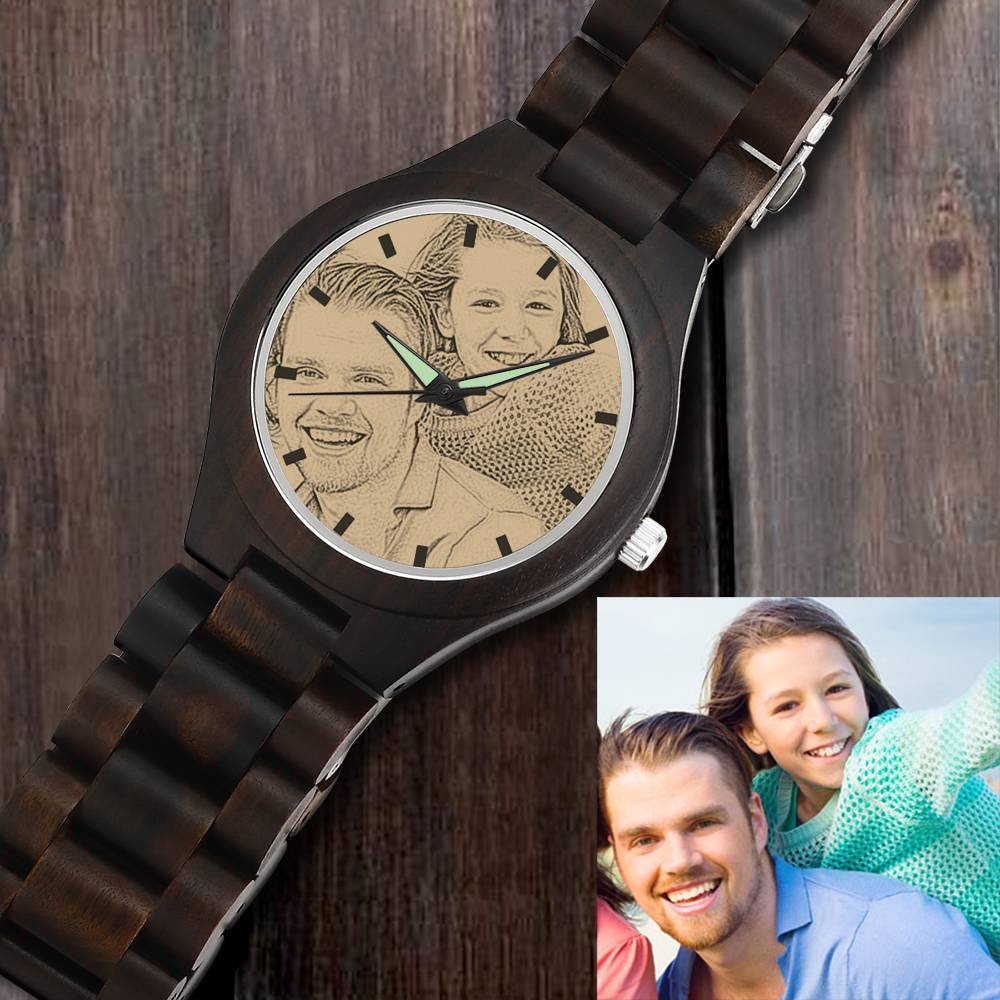 Wooden watch with engraved faces on the dial, displayed against a wooden background.