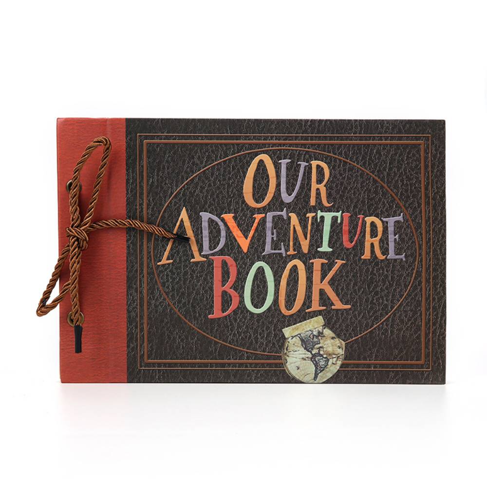 Book titled 'Our Adventure Book' with a red cover and decorative elements on a white background
