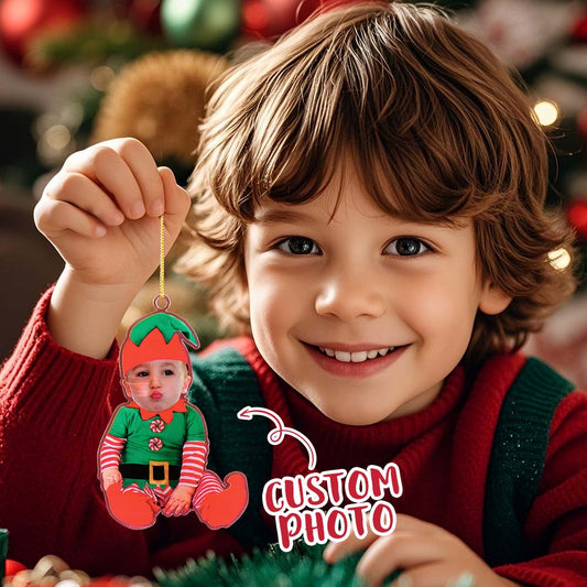 Child holding a Christmas ornament with a custom photo of another child, surrounded by festive decorations.