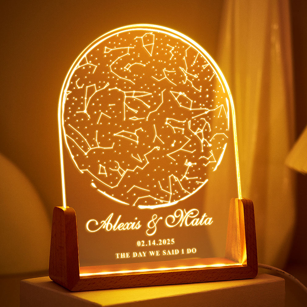 Decorative lamp with star constellations and personalized text on a wooden base.