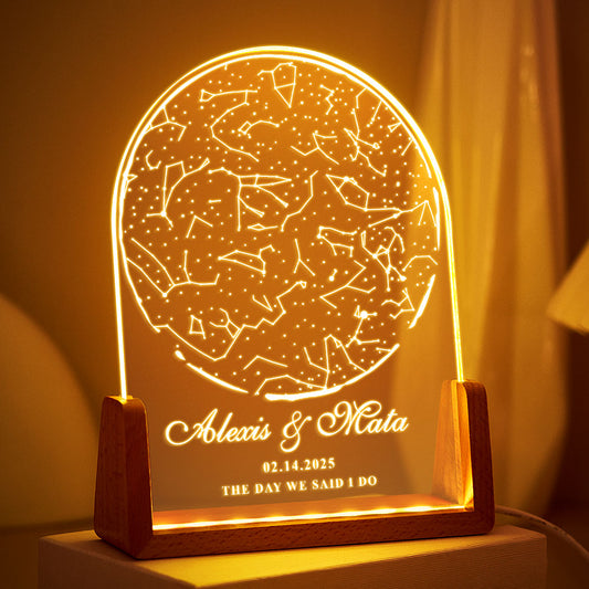 Decorative lamp with star constellations and personalized text on a wooden base.